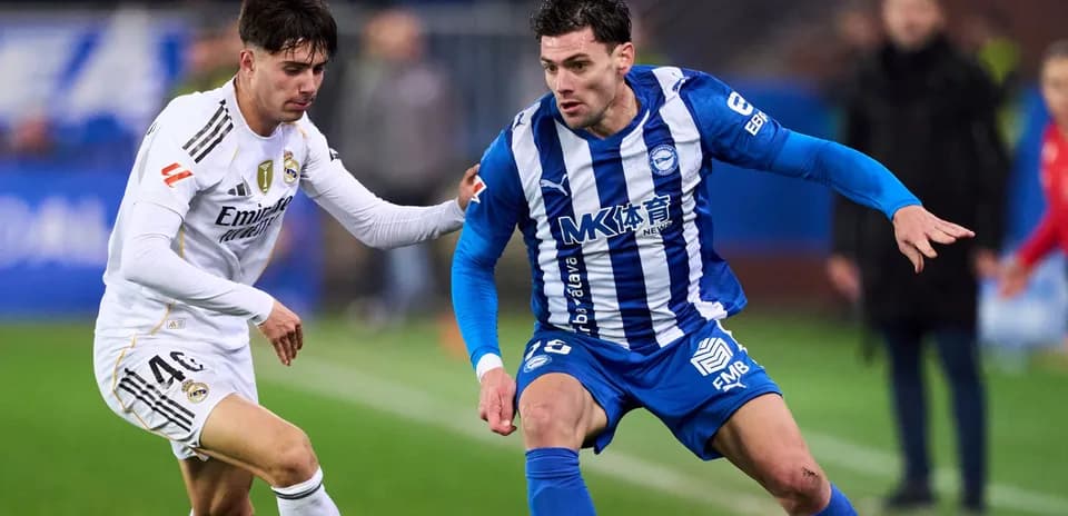 Two players contesting for the ball on the field
