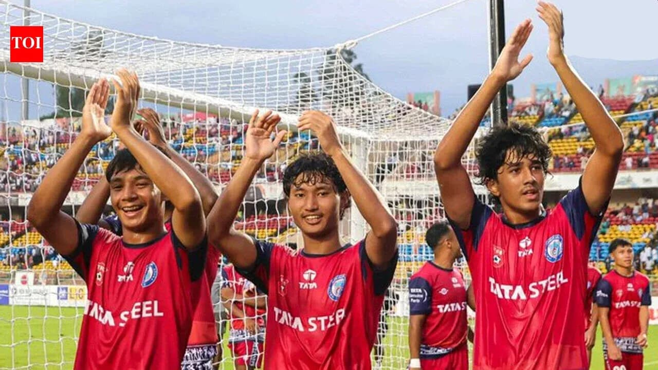 Three players celebrating in team jerseys after match