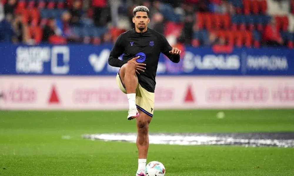 Player stretching leg during warm-up on pitch