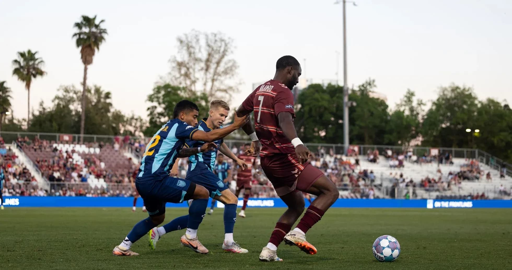 Players competing for the ball in football match
