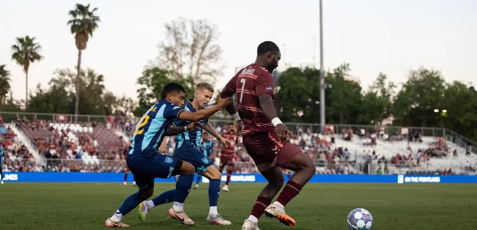 Players competing for the ball in football match