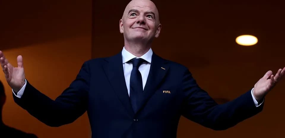 FIFA president gesturing from VIP box at event