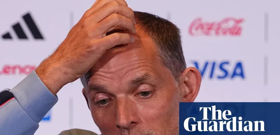 Coach speaking at press conference, hand on head