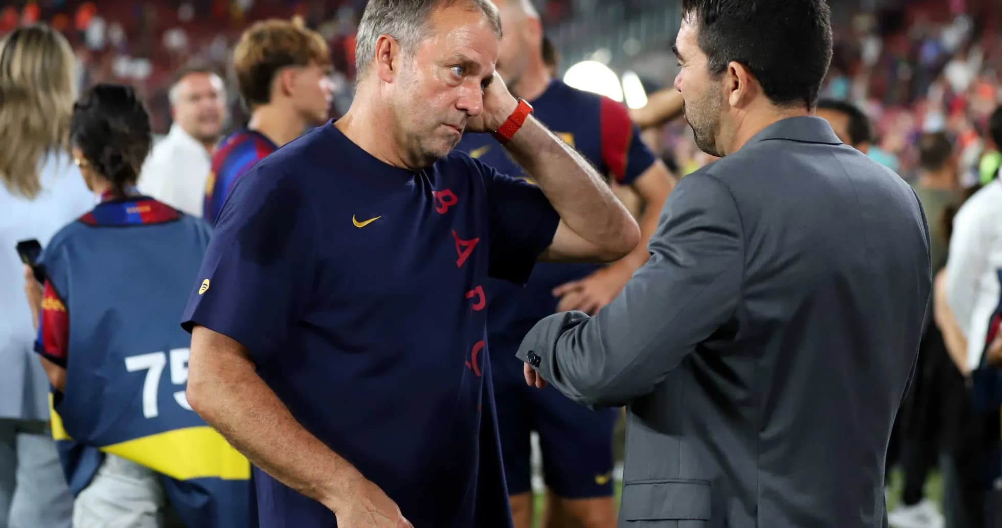 Coaches discussing on the pitch after match