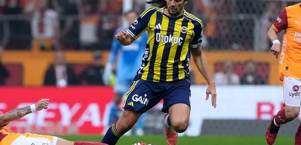 Fenerbahçe player dribbling past opponent on field