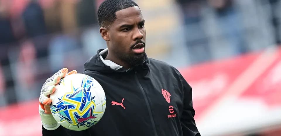Goalkeeper holding a ball during warm-up session
