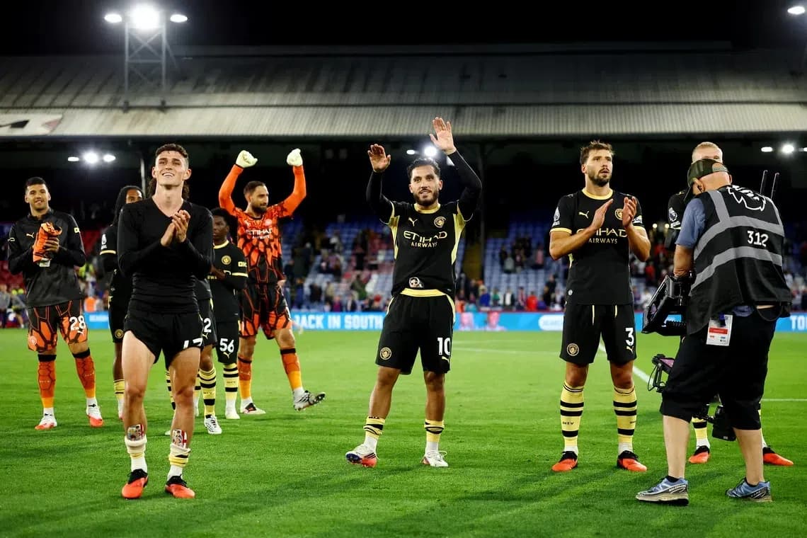 Players celebrating and applauding fans after match