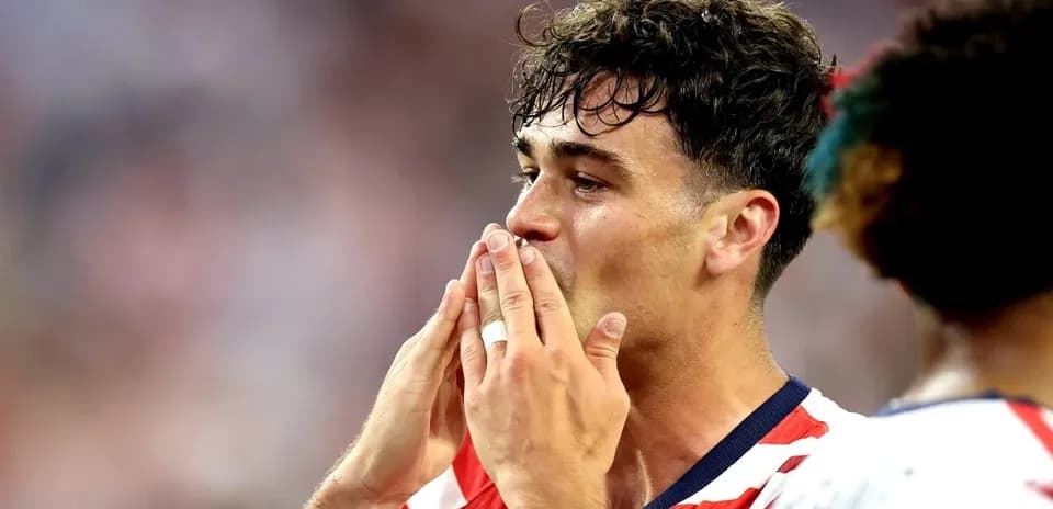 Player celebrating with hands near face during match