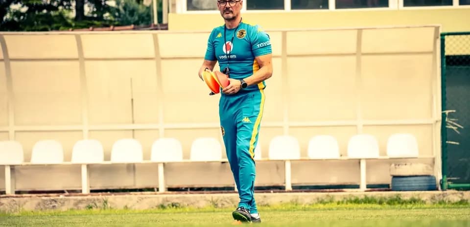 Coach holding training cones on field