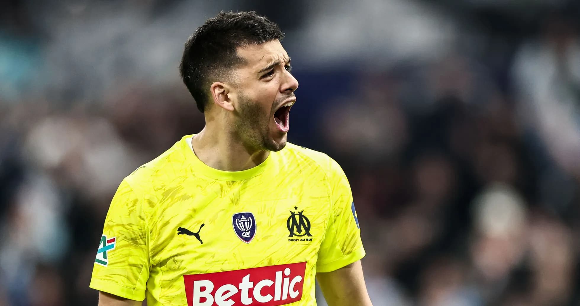 Goalkeeper shouting in bright yellow uniform