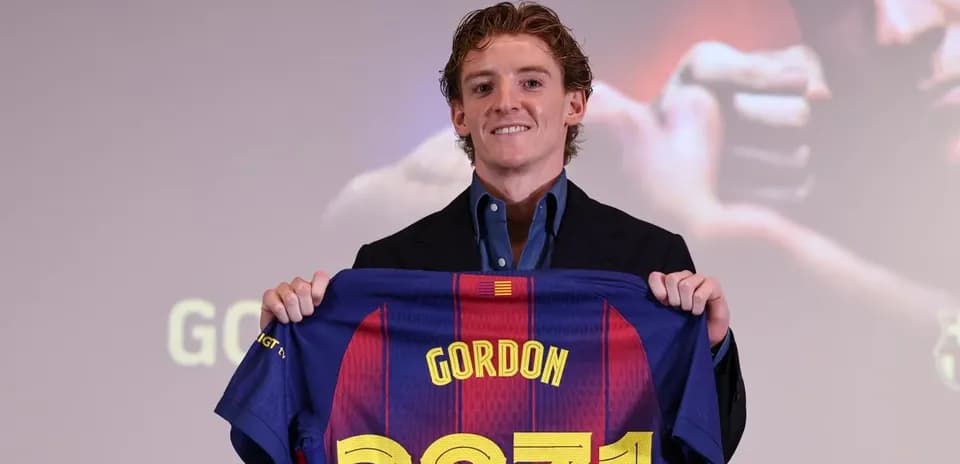 Player holding FC Barcelona jersey at presentation