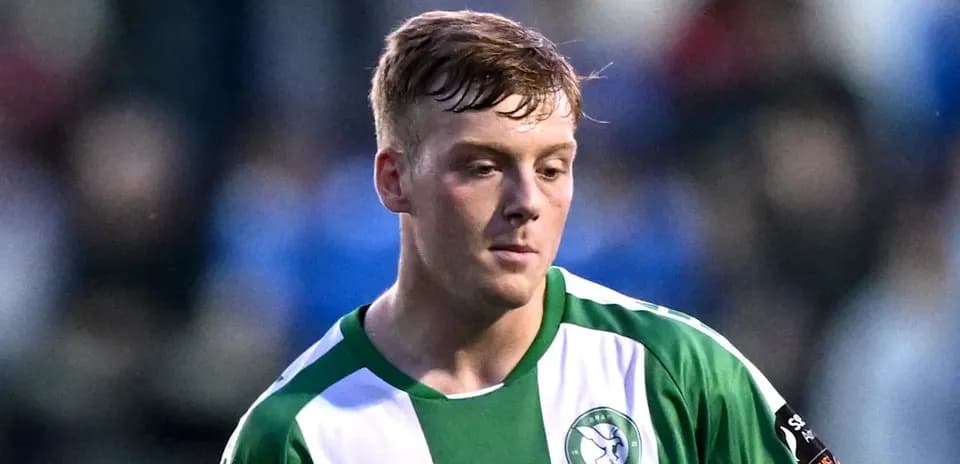 Player in green and white kit during match