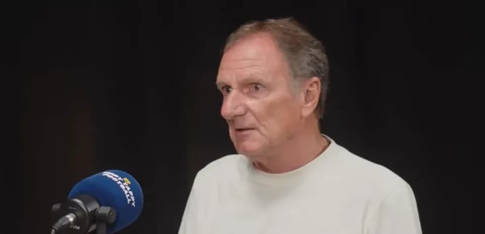 Person speaking at a microphone during an interview
