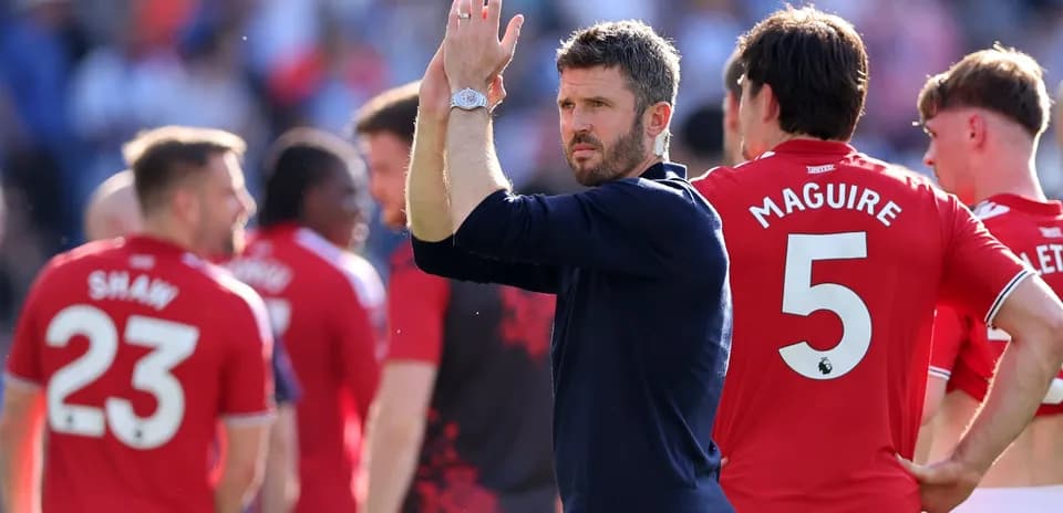 Manager applauding players after match in stadium