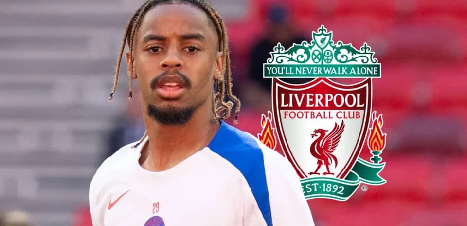 Player in training gear with Liverpool logo backdrop