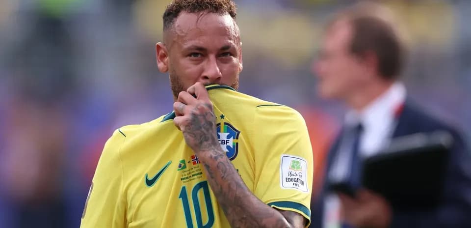 Neymar touching his jersey during a match