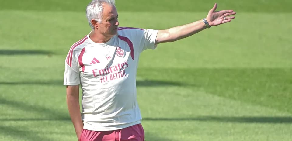 Coach directing players during training session on field
