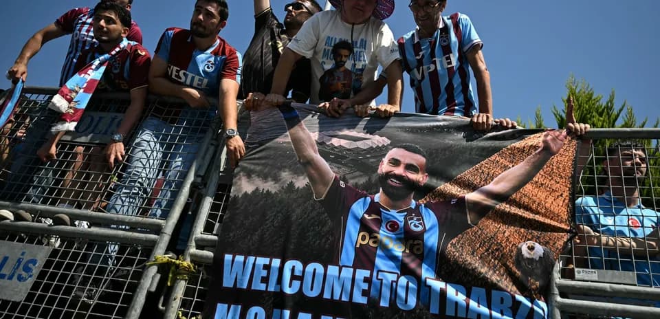 Fans holding a welcome banner for Mohammed Salah