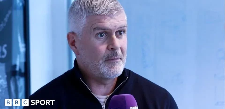 Man speaking into microphone during interview session
