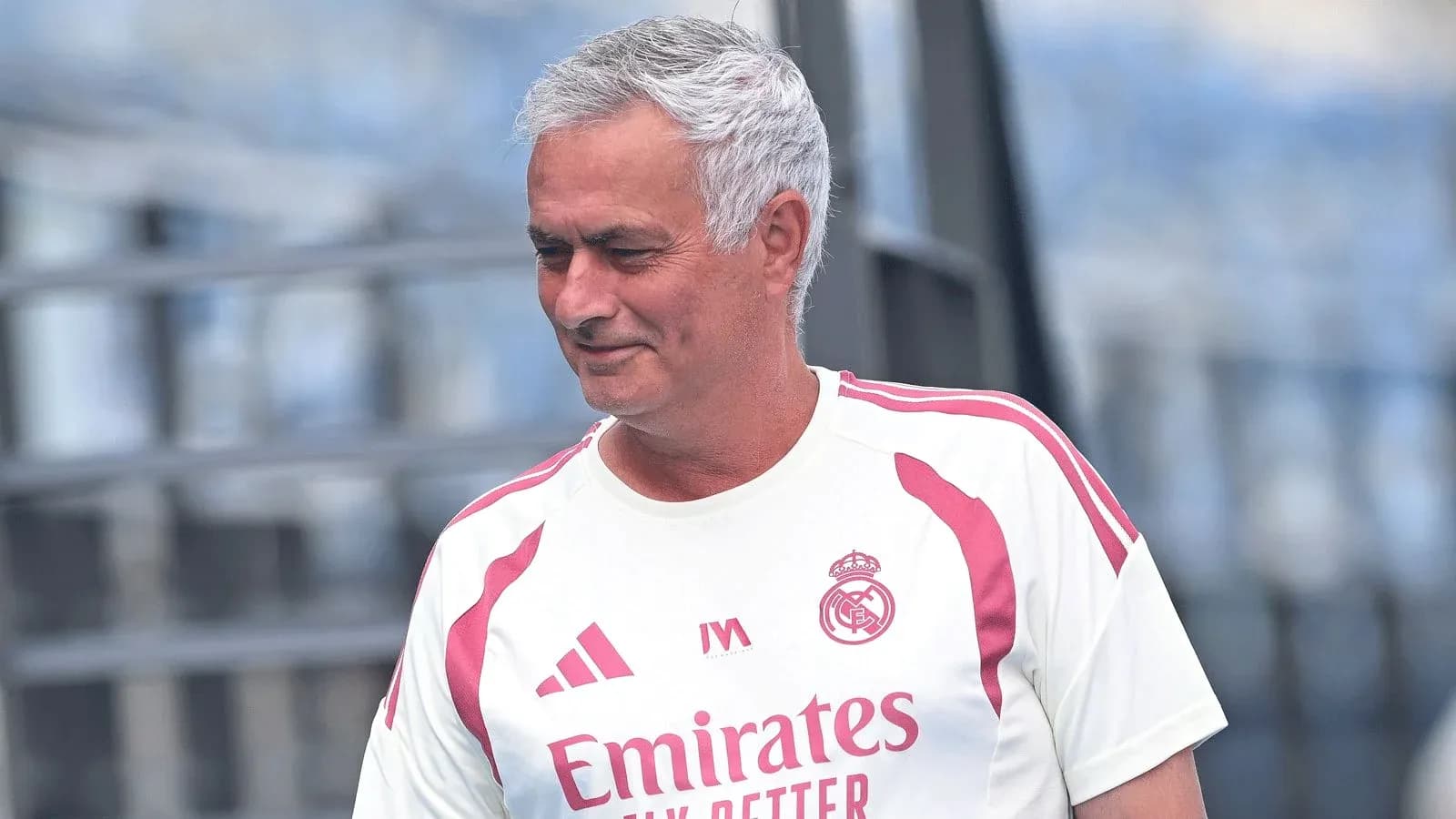 Coach in Real Madrid training kit on pitch