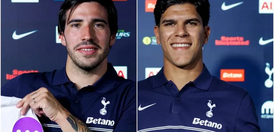 Two players presenting jerseys at press conference