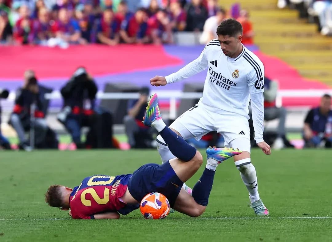 Barcelona player tackled by Real Madrid opponent
