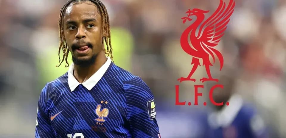 Player in France kit during match with Liverpool logo