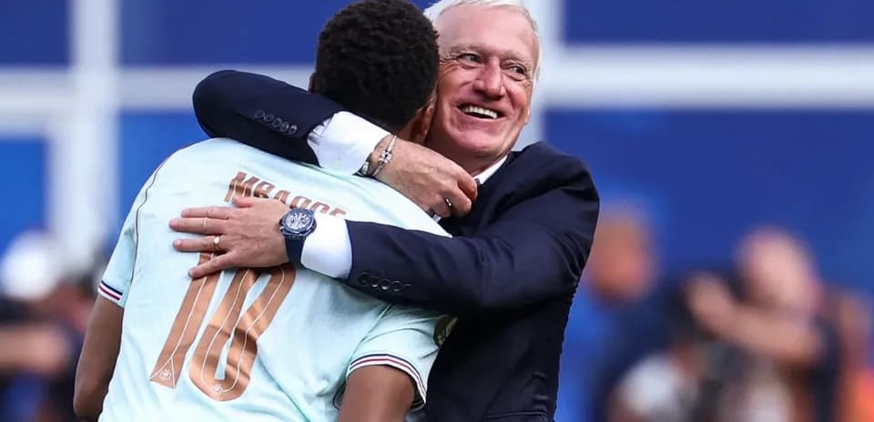 Player embracing coach after match celebration