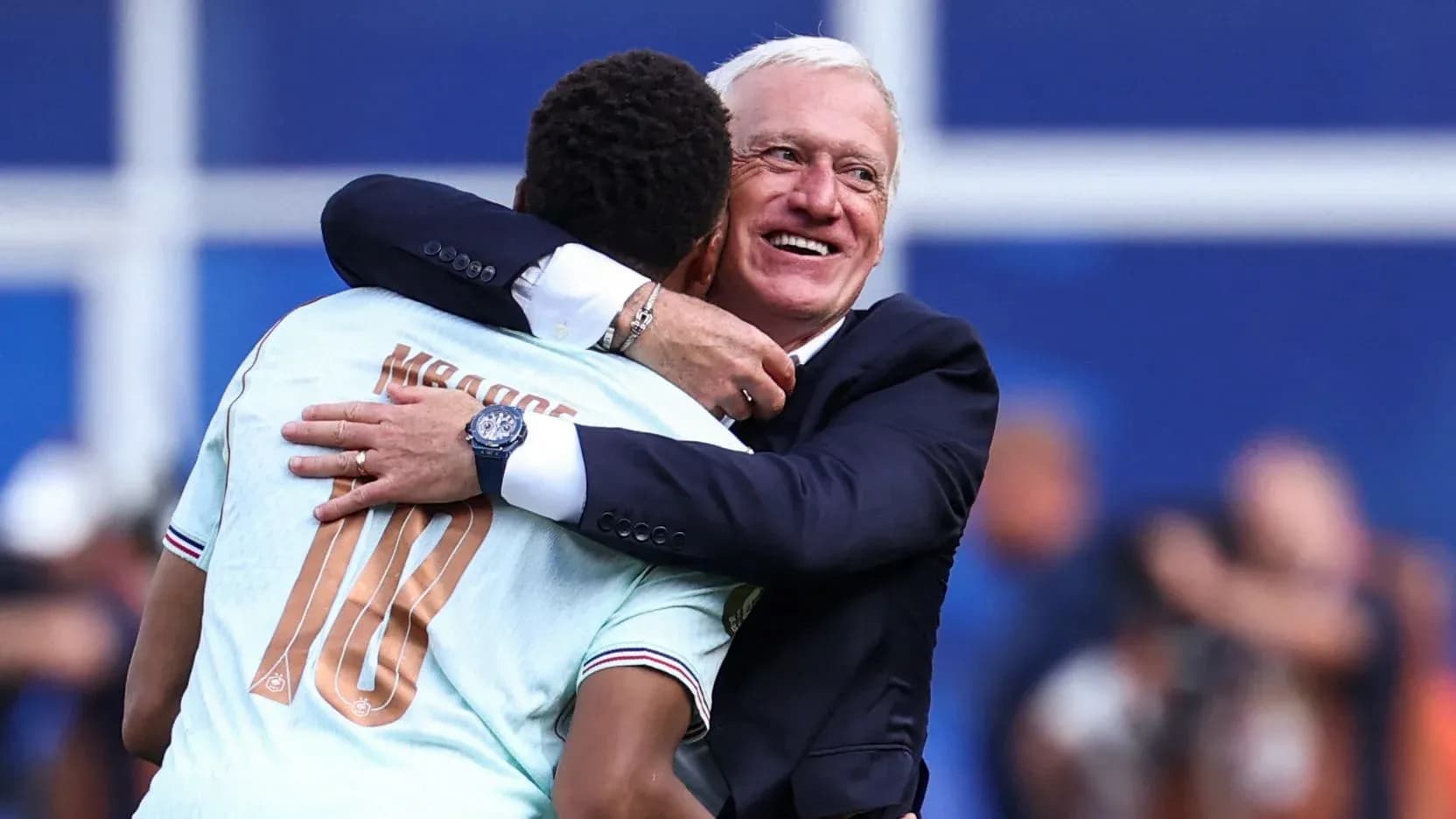 Player embracing coach after match celebration