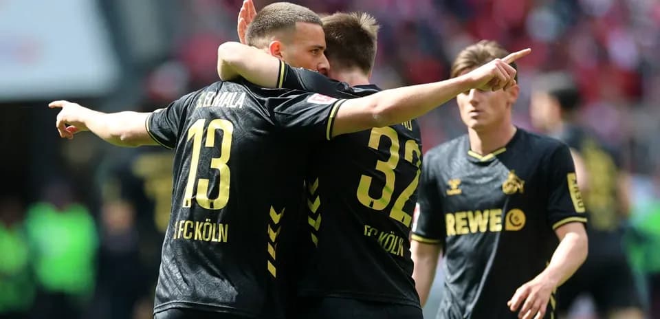 Two FC Köln players celebrating a goal together
