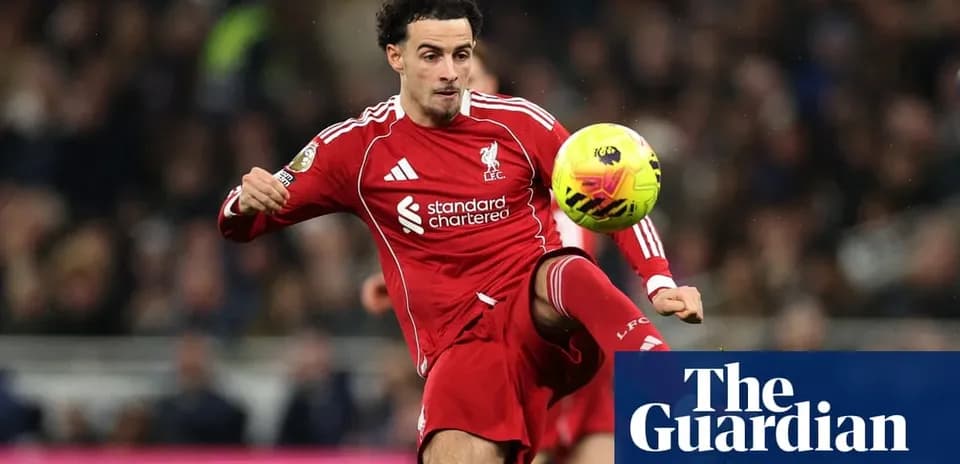 Liverpool player controlling ball during match action