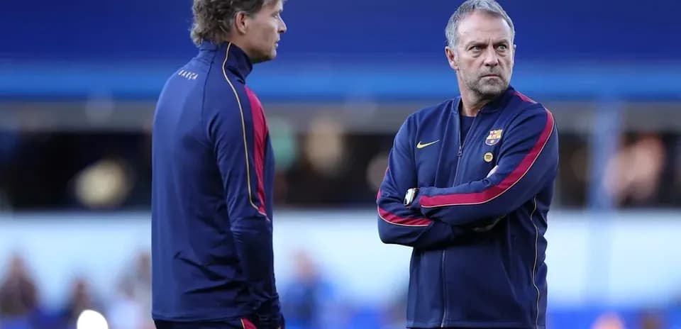Two coaches discussing strategy on the sidelines