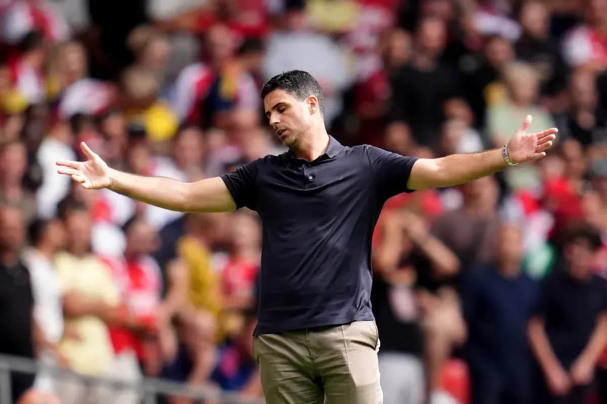 Manager gesturing to fans during a match