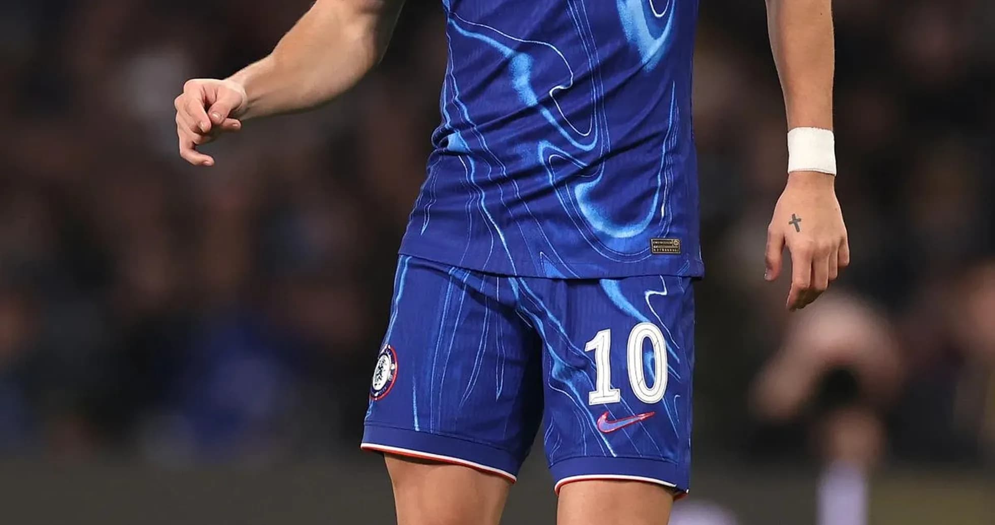 Player in Chelsea kit with ball on the pitch