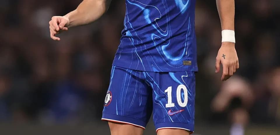 Player in Chelsea kit with ball on the pitch