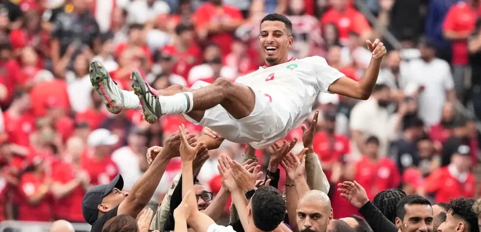 Player being celebrated by teammates after victory