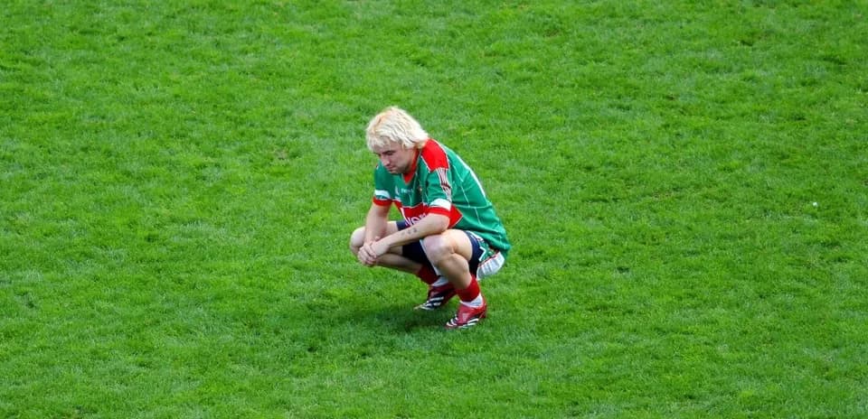 Player squatting on the field during a match