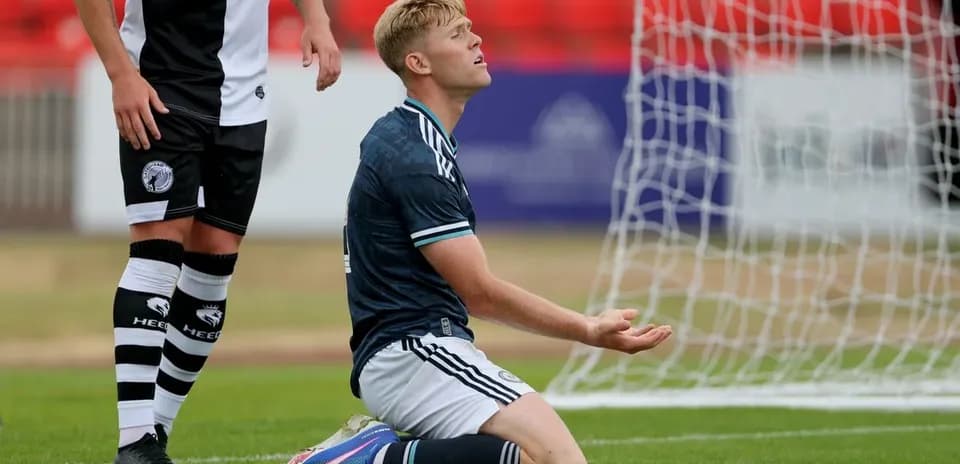 Player on knees in front of goal during match