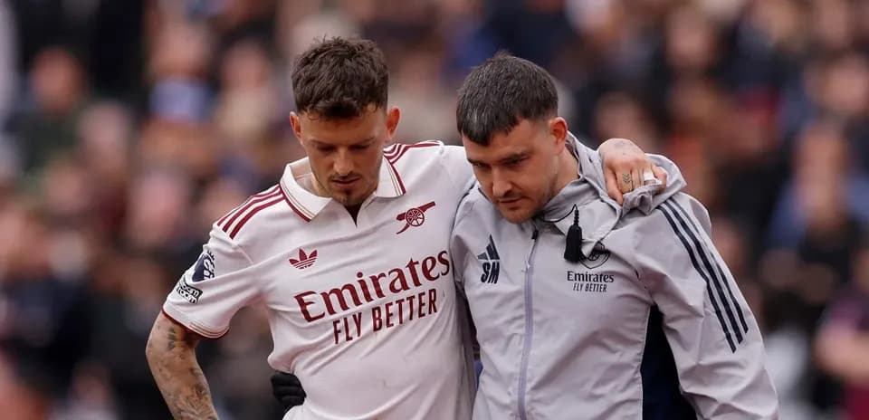 Player assisted off the field by staff member