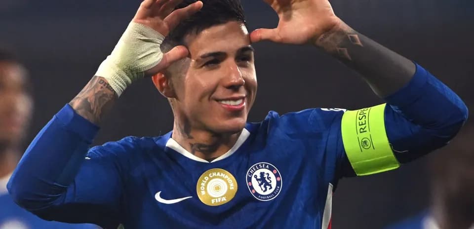 Player celebrating with arms raised in Chelsea kit
