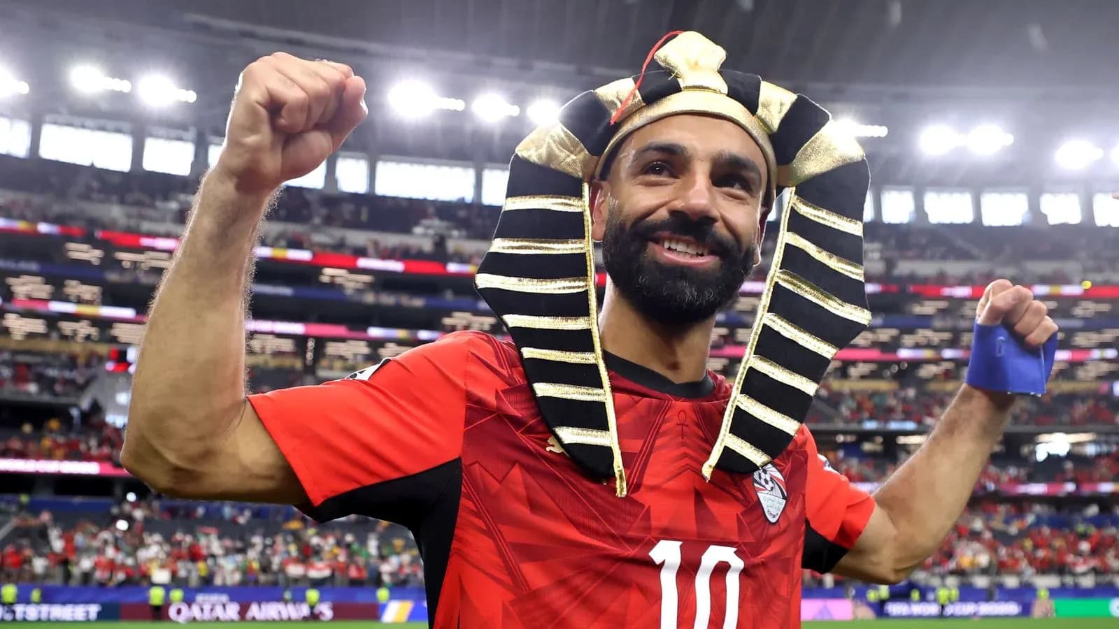 Player celebrating in Pharaoh headdress after match