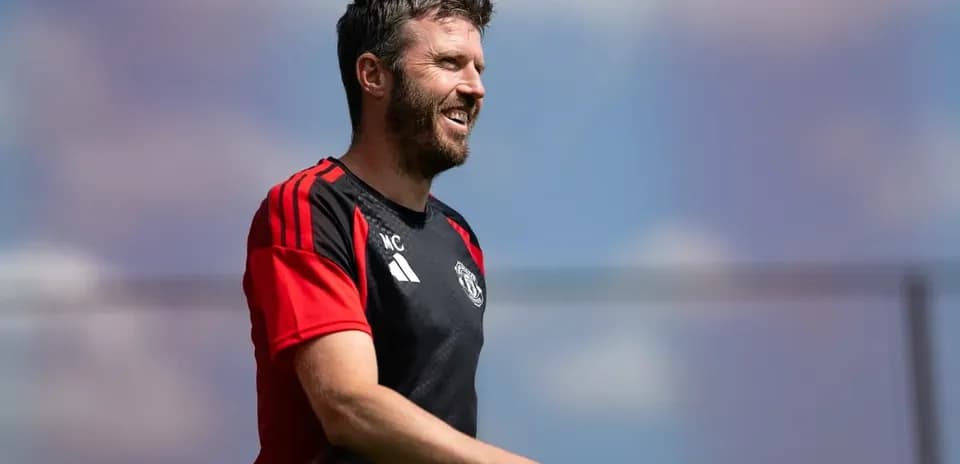 Coach smiling during training session at pitch