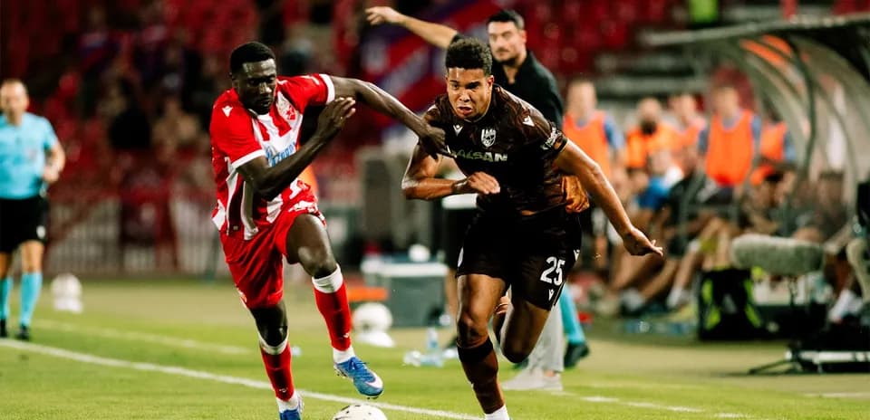 Player competing for the ball during UEFA match