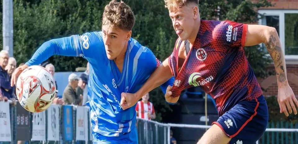 Two players competing for the ball in a match