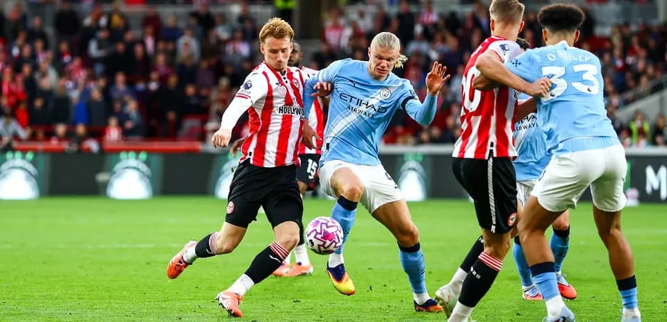 Manchester City player dribbling against Brentford defender
