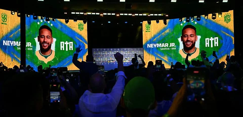 Crowd at event with Neymar Jr. displayed on screens