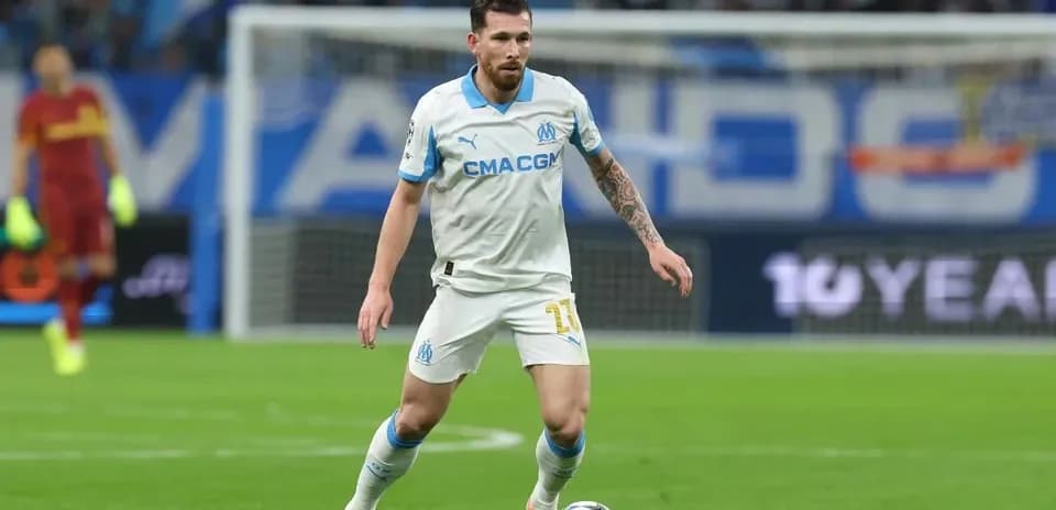 Player in white jersey dribbling ball on field