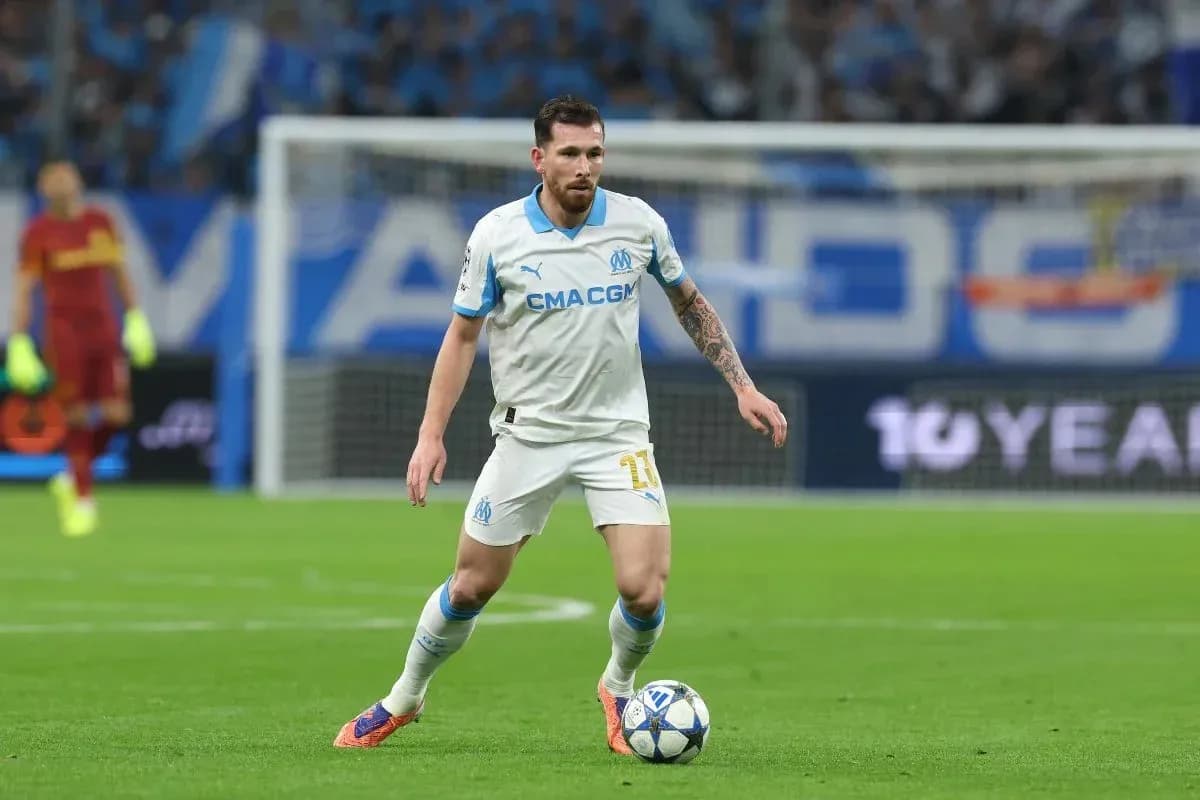 Player in white jersey dribbling ball on field