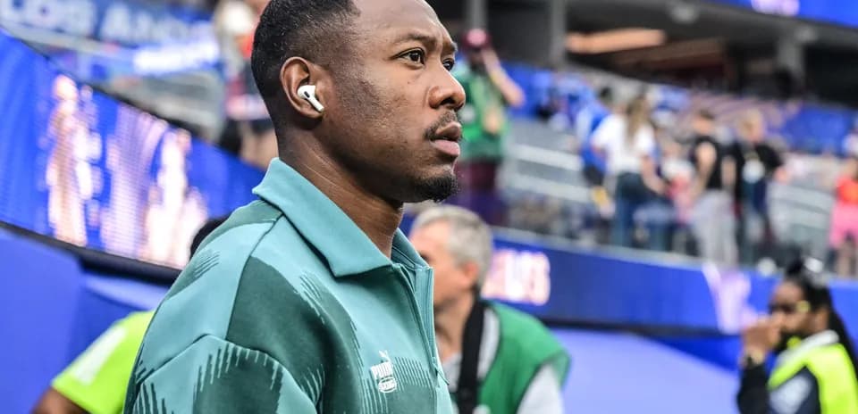 Player wearing earbuds on sidelines before match