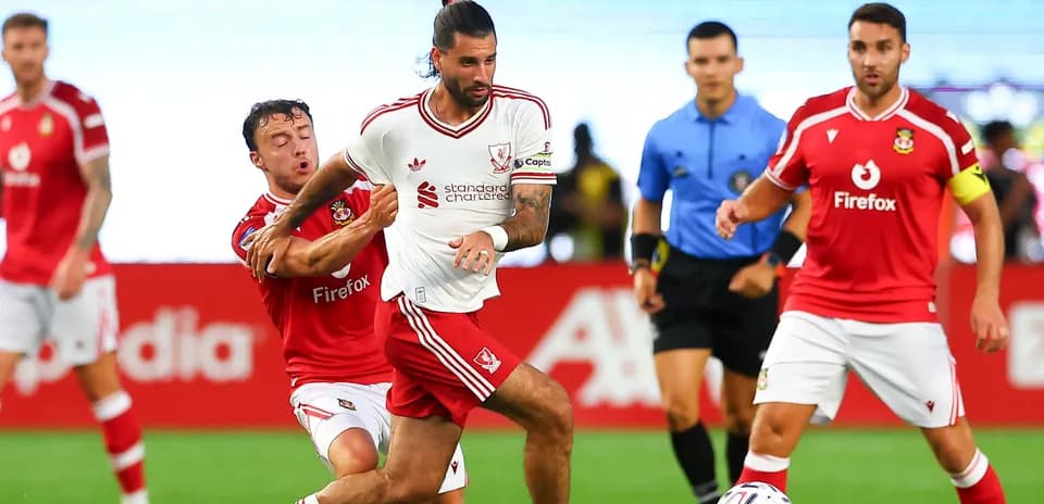 Player in white evading opponent during football match
